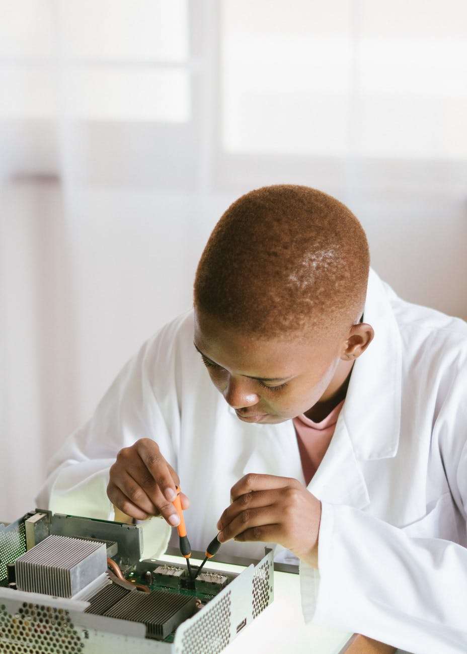 Technician inspecting computer hardware before deciding whether to repair or replace it